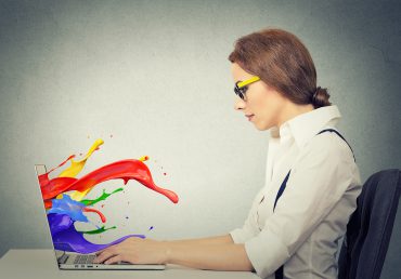 Image of laptop with vibrant colour splashing out of screen