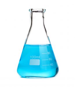 glass beaker filled with 100 mL of translucent, light-blue liquid