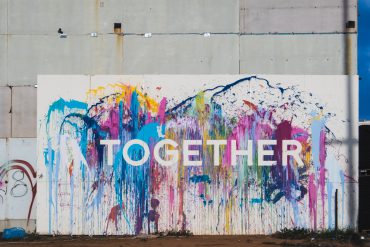 Image of the word "together" spray painted onto a wall