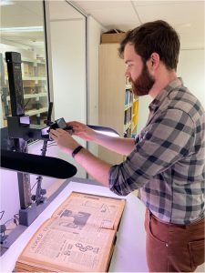 Hamish, another HSTY3902 student, works behind the scenes at the Sydney Jewish Museum using a high-tech machine to inspect an old book.
