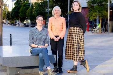 Portrait of (left to right) Alessandra, Joanne and Alix, on Eastern Avenue on the Camperdown campus, in the afternoon light