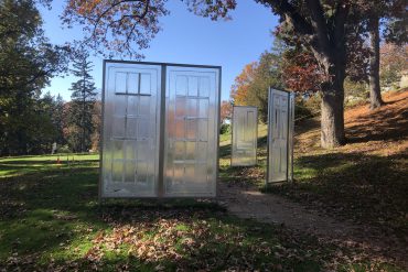 Photo of an outdoor sculpture depicting transparent doors
