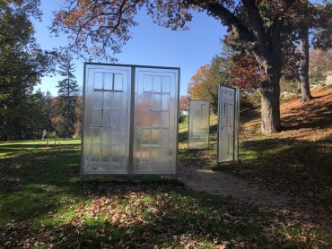 Photo of an outdoor sculpture depicting transparent doors