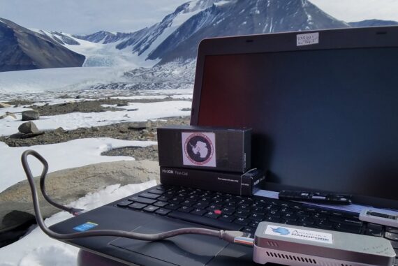 A laptop computer connected to an Oxford Nanopore MinION sequencing device, in Antarctica